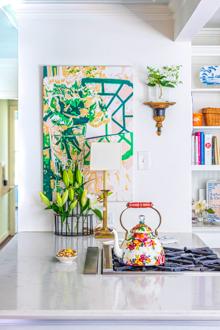 Susie Kwiatkowski's home tour captures her curated aesthetic perfectly. The kitchen is a blend of antiques with Susie's colorful, floral oil paintings.
